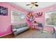 Bright pink bedroom featuring a modern sofa and stuffed animal hammock at 5552 Odessa St, Denver, CO 80249