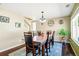 Elegant dining room with a large table, hardwood floors, and a modern chandelier at 5552 Odessa St, Denver, CO 80249