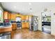 Well-lit kitchen with stainless steel appliances, wooden cabinetry, and tile floors at 5552 Odessa St, Denver, CO 80249