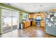 Bright kitchen with stainless steel appliances, wood cabinets, and a sliding glass door to the patio at 5552 Odessa St, Denver, CO 80249
