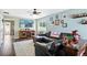 Comfortable living room featuring a leather sofa, decorative shelving, and hardwood floors at 5552 Odessa St, Denver, CO 80249