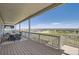 Wide back deck with covered seating, a view of the neighborhood, and steps to the yard at 14440 Hop Clover Trl, Parker, CO 80134