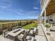 A beautiful backyard with an outdoor fire pit, comfortable seating, and a stunning view overlooking lush greenery at 14440 Hop Clover Trl, Parker, CO 80134