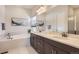 This primary bath boasts double sinks, a soaking tub, large mirror and lots of counterspace at 14440 Hop Clover Trl, Parker, CO 80134