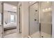 This modern bathroom features a glass enclosed shower, white subway tiles and bright lighting at 14440 Hop Clover Trl, Parker, CO 80134