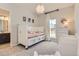 This bedroom features a cute bed, changing table, and view of the outdoors at 14440 Hop Clover Trl, Parker, CO 80134