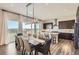Dining area with long table and chairs, modern lighting fixture, and amazing views at 14440 Hop Clover Trl, Parker, CO 80134