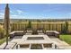 Cozy backyard fire pit with comfortable seating and a scenic view, creating a perfect outdoor gathering space at 14440 Hop Clover Trl, Parker, CO 80134