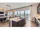 Kitchen island with white countertops and view of dining area and backyard at 14440 Hop Clover Trl, Parker, CO 80134