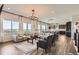 Open concept living room with modern chandelier and large windows with amazing views at 14440 Hop Clover Trl, Parker, CO 80134