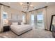Bright primary bedroom with balcony access offers stunning views of the city and modern lighting at 14440 Hop Clover Trl, Parker, CO 80134