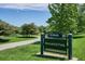 Welcoming park sign amidst lush greenery and a paved walking path at 7340 E Princeton Ave, Denver, CO 80237