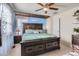 Spacious bedroom with a large bed, ceiling fan, and ample storage at 10699 Durango Pl, Longmont, CO 80504