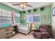 Bedroom with crib, chair, and soothing green walls at 10699 Durango Pl, Longmont, CO 80504