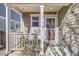 Covered front porch with a swing, providing a relaxing outdoor space at 10699 Durango Pl, Longmont, CO 80504