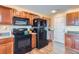 Kitchen with wood cabinets, black appliances, and a spacious layout at 10699 Durango Pl, Longmont, CO 80504