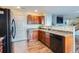 Kitchen boasts wood cabinets, black appliances, and ample counter space at 10699 Durango Pl, Longmont, CO 80504