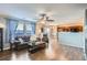 Open living room with hardwood floors, a view of kitchen, and a fireplace at 10699 Durango Pl, Longmont, CO 80504