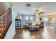 Bright living room with hardwood floors, comfortable seating, and a view of the dining area at 10699 Durango Pl, Longmont, CO 80504