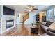 Spacious living room featuring hardwood floors, fireplace, and ceiling fan at 10699 Durango Pl, Longmont, CO 80504