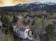 Aerial view of a charming home nestled among trees, with views of the city and mountains in the background at 218 Highland Ter, Breckenridge, CO 80424