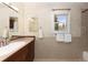 Elegant bathroom featuring a wood vanity with marble countertop and decorative wallpaper at 218 Highland Ter, Breckenridge, CO 80424