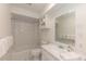 Bright bathroom with white tile, tub with shower, and vanity sink with a large mirror at 218 Highland Ter, Breckenridge, CO 80424