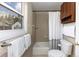 Bright bathroom with shower and tub combination, convenient built-in shelving, and a view from the window at 218 Highland Ter, Breckenridge, CO 80424