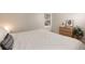 Well-lit bedroom with a queen size bed and a decorative wooden dresser beneath the window at 218 Highland Ter, Breckenridge, CO 80424