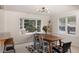 Bright dining room featuring a bay window and seating for six, open to the living room at 218 Highland Ter, Breckenridge, CO 80424