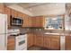Bright kitchen showcases light wood cabinetry, stainless steel microwave, and a white range at 218 Highland Ter, Breckenridge, CO 80424