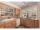 Kitchen area boasts bright light, wooden cabinetry, tile countertops and dishwasher at 218 Highland Ter, Breckenridge, CO 80424
