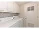 Functional laundry room equipped with a washer and dryer, storage cabinets, and a vented door at 218 Highland Ter, Breckenridge, CO 80424