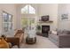 Bright living room with vaulted ceilings, fireplace, view, and balcony access at 218 Highland Ter, Breckenridge, CO 80424