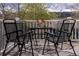Outdoor seating area on a deck, set against the backdrop of lush trees and snow-capped mountains at 218 Highland Ter, Breckenridge, CO 80424