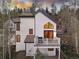 Two-story home with a red-framed triangular window and a white balcony overlooking the hillside at 218 Highland Ter, Breckenridge, CO 80424