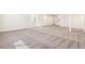 Spacious carpeted basement area with white walls and stairs leading to the upper level at 9314 Biscay St, Commerce City, CO 80022
