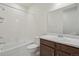 Bathroom featuring a white tub, toilet, sink, and dark vanity, creating a clean and functional space at 9314 Biscay St, Commerce City, CO 80022
