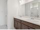 Bathroom featuring a double sink vanity with a large mirror and a separate room with a shower at 9314 Biscay St, Commerce City, CO 80022