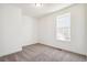 Bright bedroom features neutral carpeting and a sunny window at 9314 Biscay St, Commerce City, CO 80022