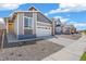 Charming exterior displaying modern architecture, a two-car garage, and rock landscaping at 9314 Biscay St, Commerce City, CO 80022