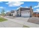 Beautiful modern home featuring desert landscaping, fenced yard and a two-car garage at 9314 Biscay St, Commerce City, CO 80022