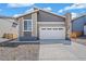 Charming home boasts a modern design, two-car garage and unique stone-accented chimney at 9314 Biscay St, Commerce City, CO 80022