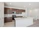 A spacious kitchen with a large island, stainless steel appliances, and recessed lighting at 9314 Biscay St, Commerce City, CO 80022