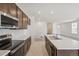 Modern kitchen with stainless steel appliances, granite countertops and spacious open layout at 9314 Biscay St, Commerce City, CO 80022