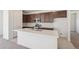 Stylish kitchen featuring stainless appliances, granite countertops, and a white island at 9314 Biscay St, Commerce City, CO 80022