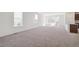 Spacious living room filled with natural light, neutral walls, and plush carpeting at 9314 Biscay St, Commerce City, CO 80022