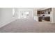Bright, open-concept living space featuring large windows, plush carpeting, and a stylish kitchen at 9314 Biscay St, Commerce City, CO 80022