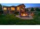 Stunning backyard with a stone patio, fire pit, and beautiful outdoor living space at 4651 Sonado Pl, Parker, CO 80134