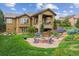 Beautiful backyard with a stone patio, inviting fire pit, and lush landscaping at 4651 Sonado Pl, Parker, CO 80134